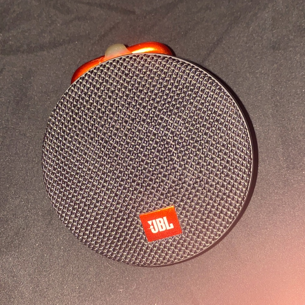 JBL clip speaker its loud and portable, bluetooth , you can talk on the phone to